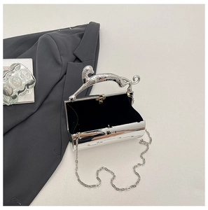 Detail view of silver luxury evening clutch with leopard handle and metal chain strap