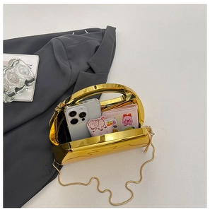 Detail of gold mirror metal handbag showing spacious interior for phone and accessories