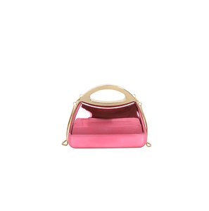 Detail of glossy pink mirror finish evening clutch with gold handle and chain