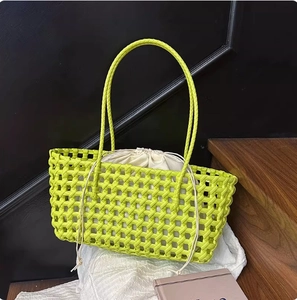 Detail of neon green woven tote bag featuring a white drawstring inner pouch and open knit