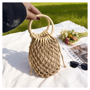 Macro detail of hand-woven cotton rope texture with round wooden handles and fabric lining