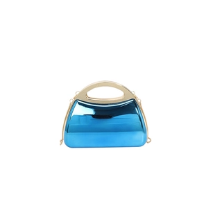 Detail of blue electroplated evening bag with a gold metal handle and chain strap