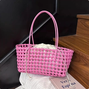 Detail of pink hand-woven tote bag with cream drawstring liner and thick braided handles