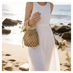 Detail of hand-woven hollow beach bag with wooden handles and cotton drawstring liner
