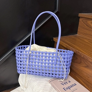 Handwoven purple mesh basket bag with white drawstring liner and long handles
