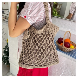 Close-up of khaki crochet woven tote bag with retro mesh structure and inner lining