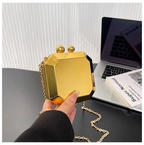 Detailed view of an octagonal gold mirror box clutch with sphere clasps and chain