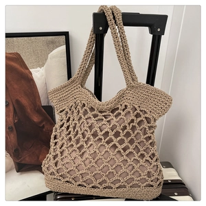 Macro detail of hand-woven latte cotton rope bag showing hollow mesh and fabric lining