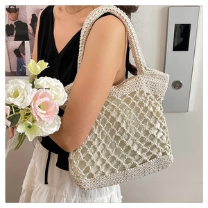 Detail of hand-woven cotton rope tote bag with mesh hollow design and inner lining