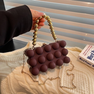 Chocolate bubble texture evening clutch bag with gold beaded handle and metal chain