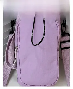 Close-up of purple nylon crossbody phone bag featuring custom textured fabric and black straps
