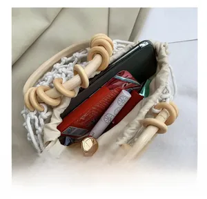 Detail view of woven cotton tote bag with wooden handle showing spacious inner storage