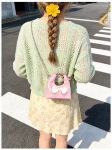 Toddler girl pink bow crossbody mini chain bag styled with floral outfit on city street