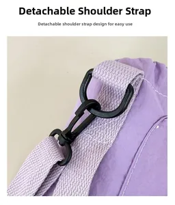 Detail view of the detachable purple shoulder strap with durable swivel lobster clasp