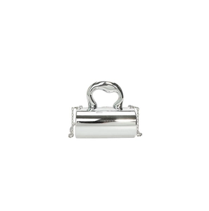 Macro shot of silver mirror-finish cylindrical evening bag with organic handle and chain