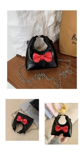 Detailed views of mini black crossbody bag with red bow and metallic chain strap