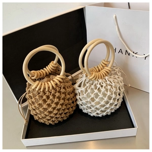 Detail of hand-woven cotton rope bags with round wooden handles and drawstring liners