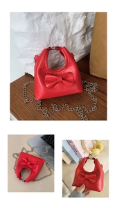 Close-up of red toddler crossbody bag with large bow detail and silver chain strap