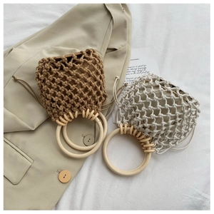 Detail of hand-woven cotton mesh bags with wooden handles and drawstring liners