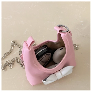 Pink girl's crossbody bag interior capacity with chain strap and bow detail