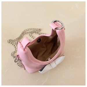 Close-up of pink girls bow crossbody bag showing inner space and magnetic buckle closure