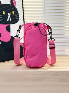 Pink nylon crossbody phone bag with drawstring bucket compartment and adjustable strap