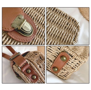 Close-up of straw woven texture with bronze clasp and protective metal bottom studs