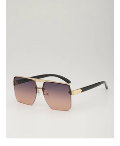 Macro detail of oversized rimless sunglasses featuring purple-orange gradient lenses and gold trim