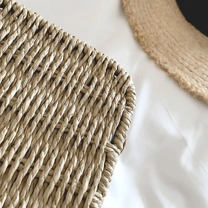 Macro detail showing natural woven texture of straw handbag with rustic beach aesthetic
