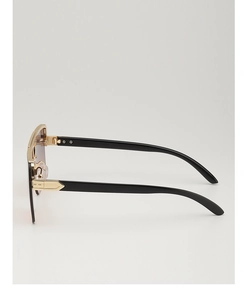 Detail of gold metal frame with grid patterns on black temples of luxury sunglasses