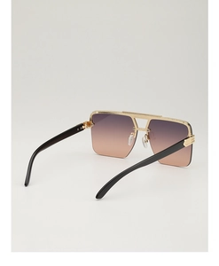 Detail of oversized square sunglasses with gradient lenses and gold metallic trim