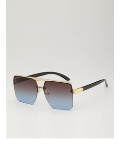 Close-up of golden metal frame square sunglasses with gradient brown to blue lenses