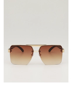 Detail view of square gold metal sunglasses with brown gradient lenses and double bridge