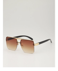 Detail view of fashion oversized square sunglasses with brown gradient lenses and gold bridge