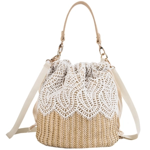 Summer bucket straw bag with white lace trim and adjustable shoulder straps for beach