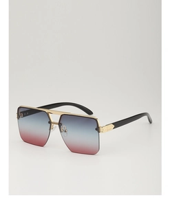 Detail of blue-pink gradient lenses and gold metal frame on fashion sunglasses
