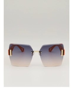 Close-up of rimless square sunglasses with gradient blue-orange lenses and gold metal accents