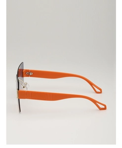 Detail of orange geometric hollow temple and diamond-cut lens on oversized sunglasses