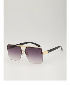 Close-up of golden metal bridge and ornate engraved details on gradient purple sunglasses