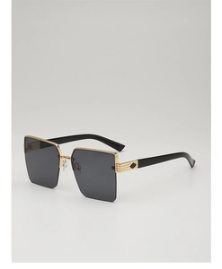 Detail of semi-rimless sunglasses showing golden chain texture and diamond hinge