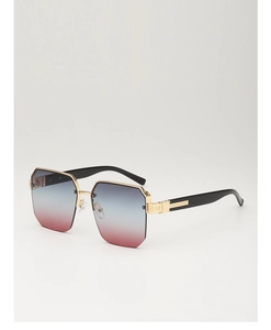 Detail view of large polygon sunglasses featuring gradient lenses and gold metal trim