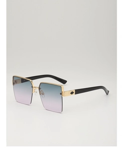 Macro detail of gold metal frame with engraved texture and gradient square lenses