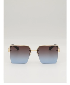 Detail of semi-rimless sunglasses with gold metal frame and gradient brown to blue lenses