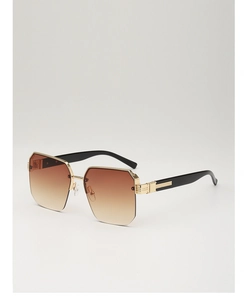 Macro detail of fashionable brown gradient lenses and gold metal geometric frame hinges