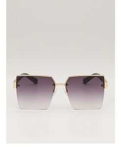 Detail of oversized half-rim sunglasses with gold metal frame and purple gradient lenses