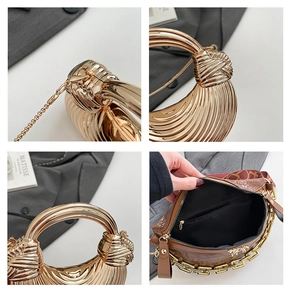 Macro detail of gold metal dinner bag showing pleats, metal handle and inner zipper pocket