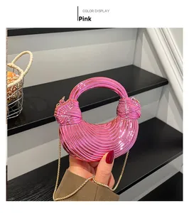 Detail of pink candy-colored acrylic mini evening bag with pleated metallic finish