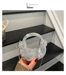 Detailed macro view of silver acrylic crescent bag with wavy texture and metal chain