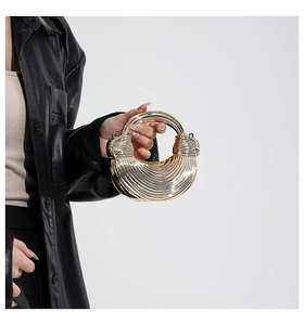 Close-up of a luxury gold metallic evening bag featuring refined pleated texture detail