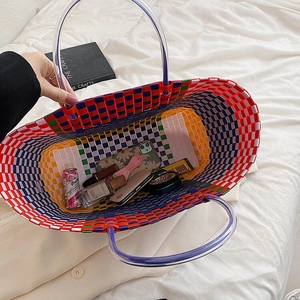Top view of colorful woven basket bag showing large capacity for phone and cosmetics